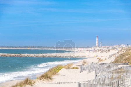 Photo for The beach of  Costa Nova do Prado at Aveiro, and the Lighthouse of Praia da Barra on the Atlantico coast of Portugal - Royalty Free Image