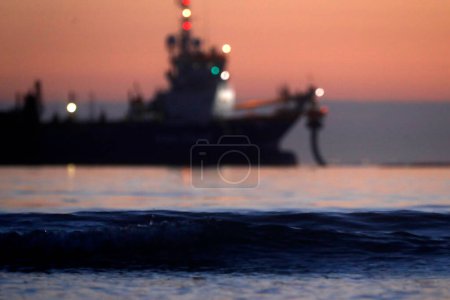 Photo for A dredger vessel taking and supplying sand for coastal protection - Royalty Free Image