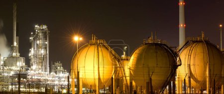A large oil-refinery plant with Liquefied Natural Gas - LNG - storage tanks