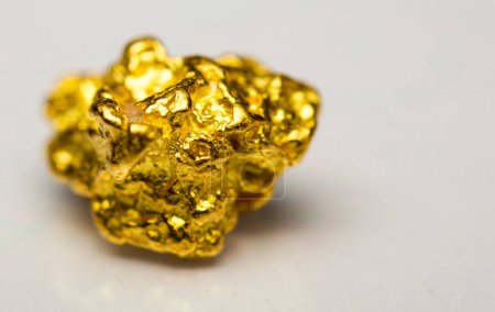 Close-up of a gold-nugget on a white background