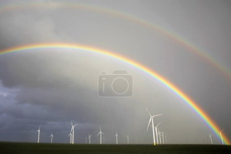 Photo for Rainbow above a offshore windpark, Breezanddijk, Holland - Royalty Free Image