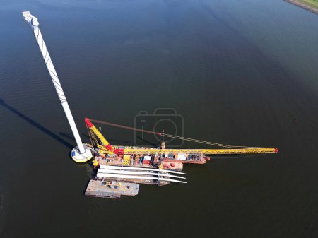 A transport ship and crane for the construction of an offshore windpark, Ijsselmeer The Netherlands