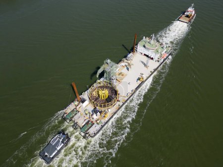 Transport of a large cable coiled onto a round frame to an offshore windpark. After construction and buried into the seabed the cable will provide electricity to the mainland