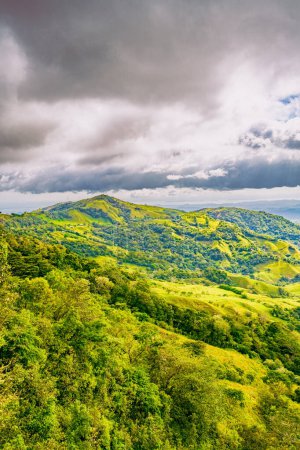 Verdant slopes of Monteverde under a dynamic sky, showcasing the rich biodiversity and layered mountain vistas of Puntarenas Province, Costa Rica. High quality photo