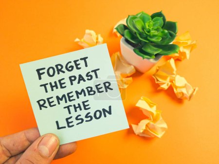 Motivational and inspirational quote - forget the past, remember the lesson handwritten on sticky note. Positive thinking, motivation, self development, inspiration concept