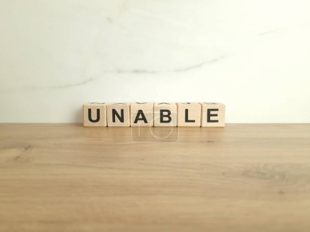Photo for Word unable made from wooden blocks. Inability, problem concepts - Royalty Free Image