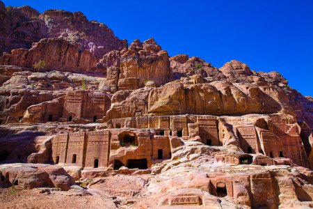 Photo for Facades of street of facades, carving in the mointains, Petra, Jordan. Bright blue sky. - Royalty Free Image