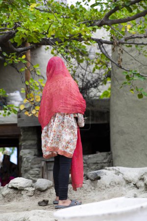 Young girl in traditional bright clothers in pakistani shia Ganish (Ganesh) village in Pakistan. 