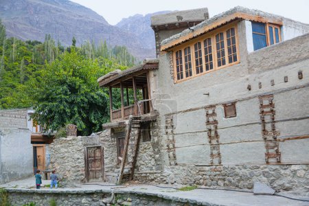 Children in the street and old buildings in Ganish village, Hunza valley, Pakistan.