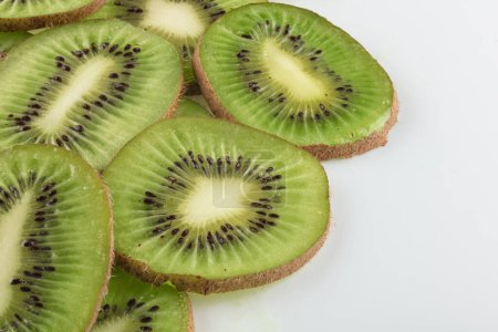 kiwi fruit cut into slices isolated on white background. Copy space.