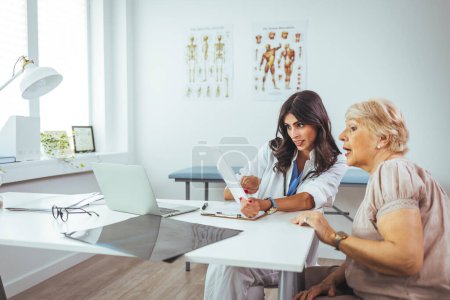 Photo for Doctor working in the office and listening to the patient, she is explaining her symptoms, healtcare and assistance concept. Woman patient visiting female doctor at clinic office. - Royalty Free Image