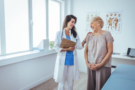 Photo for Smiling female patient at consultation with woman doctor. Patient Having Consultation With Doctor In Office. Cropped shot of a medical practitioner reassuring a patient - Royalty Free Image
