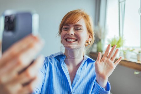 Photo for Happy beautiful gen z teen girl blogger smiling face waving hand talking to webcam recording vlog, social media influencer streaming, making video call at home. - Royalty Free Image