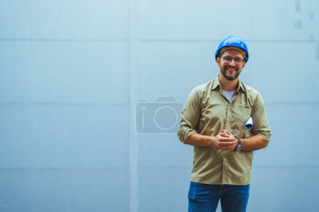 Photo for Portrait of engineer with safety helmet in front of building - Royalty Free Image