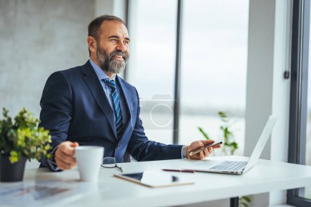 Photo for Smiling caucasian businessman working at desk in office - Royalty Free Image