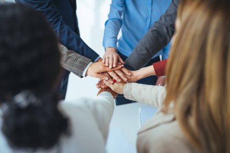 Photo for Close up view of young business people putting their hands together. Stack of hands. Unity and teamwork concept. Close-up of co-workers stacking their hands together. Diverse business people - Royalty Free Image