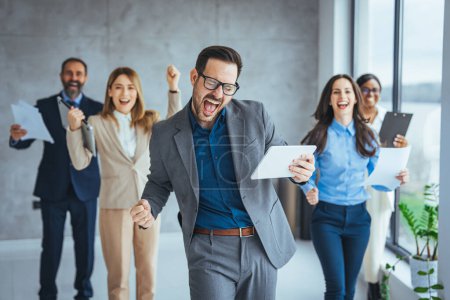 Photo for Portrait of overjoyed young diverse employees workers show thumb up recommend good quality company service. Smiling multiethnic colleagues celebrate shared business success or victory in office - Royalty Free Image