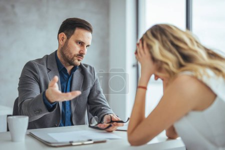 Photo for Manager is hard talking with employee in an office. Businessmen arguing at workplace, disagreeing over document, partners having conflict while negotiating, business deal failure - Royalty Free Image