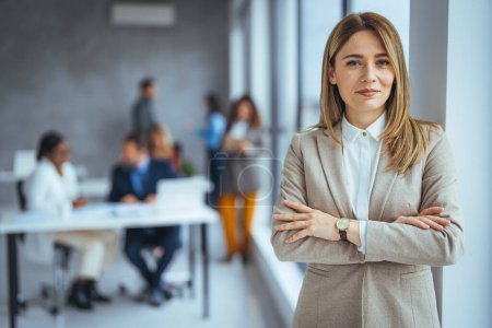 Photo for Portrait of a businesswoman standing in a a modern office. Portrait of beautyful and confident business woman. I've solidified my name in the business world. Portrait of middle aged businesswoman in modern office looking at camera. - Royalty Free Image