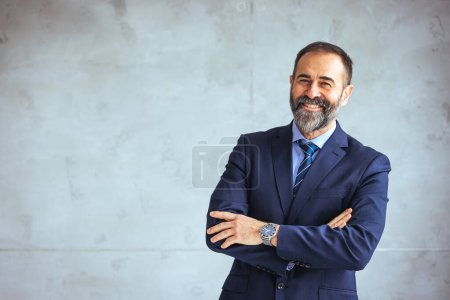 Photo for Portrait of a confident mature businessman working in a modern office. Portrait Of A Mature Man Looking At The Camera. He's confident. He's working at office. Portrait of mature businessman at modern office - Royalty Free Image