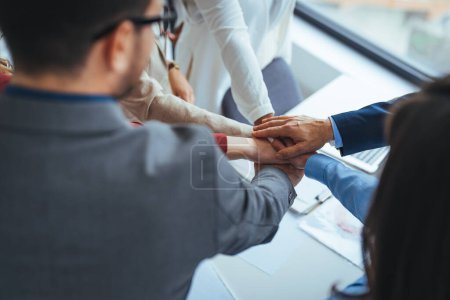 Photo for Close up top view of young business people putting their hands together. Stack of hands. Unity and teamwork concept. Cheerful people giving strength motivation. Co-working and teamwork concept - Royalty Free Image