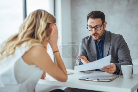 Photo for Mad male worker yelling at female colleague asking her to leave office, multiracial coworkers disputing during business negotiations, employees cannot reach agreement, blaming for mistake or crisis - Royalty Free Image