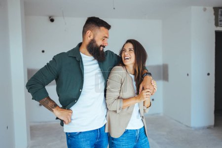 Photo for Happy young caucasian couple hugging in new apartment - Royalty Free Image