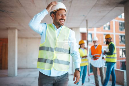 Photo for Portrait of satisfied and confident engineer with helmet and news on building site. Close-up portrait of professional architect in hard hat looking away. Attractive engineer at work on construction site - Royalty Free Image