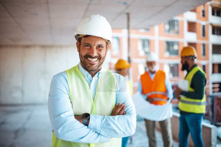 Photo for Portrait of satisfied construction site manager wearing safety vest and white helmet at construction site. Young architect watching construction site with confidence looking at camera. Manual worker on a industrial building with copy space. - Royalty Free Image