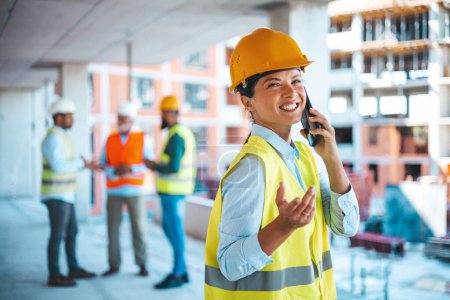Photo for Construction woman closing deal on the phone. Portrait of civil engineer woman doing business, talking on smartphone and holding tablet computer in hand, standing against high buildings and tower cranes at a construction site. - Royalty Free Image