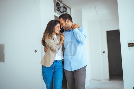 Photo for Happy Couple Dancing Together Out Of Happiness For Buying New Apartment. Young cheerful couple having fun while dancing during their home renovation process. - Royalty Free Image