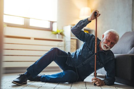 Photo for Senior man falling on the ground with walker in living room at home. Elderly older mature male having an accident heart attack for emergency help support from hospital. Insurance health care - Royalty Free Image