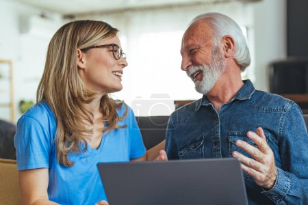 Photo for Senior man, laptop and caregiver or home nurse helping patient with social media, communication and internet browsing at home. Support, healthcare and medical aid or hospice with pensioner - Royalty Free Image