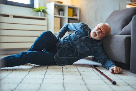 Photo for Senior man falling down on carpet and lying on the floor in living room at home, Falls of older adults concept. Senior men with cane falled down on floor at home - Royalty Free Image