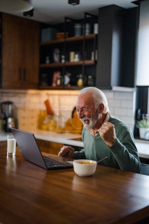 Photo for Happy excited old elderly man winner excited by reading good news looking at laptop, overjoyed senior mature grandfather watching game online celebrating goal bid bet win great result victory concept - Royalty Free Image