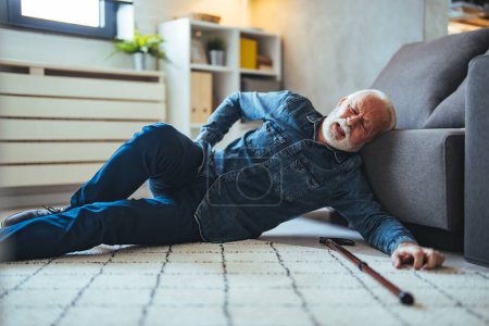 Photo for Senior man falling on the ground with walker in living room at home. Elderly older mature male having an accident headache for emergency help support from hospital. Insurance health care - Royalty Free Image