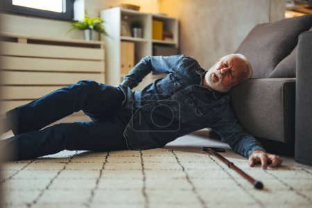 Photo for Senior man falling on the ground with walker in living room at home. Elderly older mature male having an accident heart attack for emergency help support from hospital. Insurance health care - Royalty Free Image