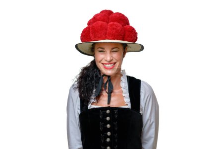 Photo for Frontal portrait of a woman wearing Black Forest traditional dress with a Bollenhut adorned with 14 red pompoms smiling at the camera isolated on white with copy space - Royalty Free Image