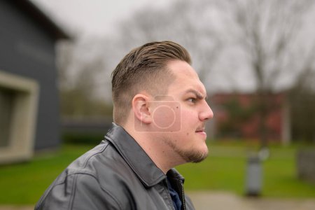 Photo for Side view of a young attractive man in his twenties looking to side with an angry emotion - Royalty Free Image