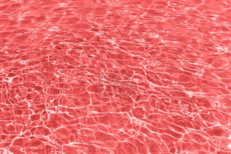 Photo for Close-up of a swimming pool filled with bright red water. The water is illuminated from below, creating an unnatural, dreamlike scene. Perfect for pool parties, night swims, or a pop-art aesthetic. - Royalty Free Image