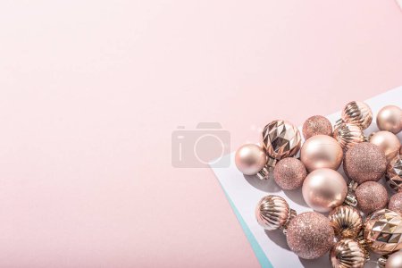 Beautiful shiny pink decorative balls on a pink background. Top view, flat lay Poster 620265034