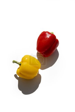 Foto de Yellow and red fresh peppers on a white background. Top view, flat lay. - Imagen libre de derechos