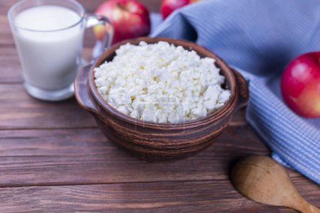 Photo for Dairy product cottage cheese in a plate on a wooden background - Royalty Free Image