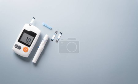 World Diabetes day concept ,14 November. Top view of blood glucose meter sets  on pastel blue background.