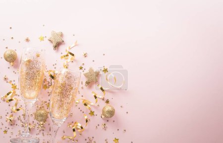Photo for Happy New year celebration background concept. Champagne glass , golden ribbon, stars and christmas ball on pastel background. - Royalty Free Image