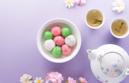 Photo for Tang Yuan(sweet dumplings balls), a traditional cuisine for Mid-autumn, Dongzhi (winter solstice ) and Chinese new year on pastel background. - Royalty Free Image