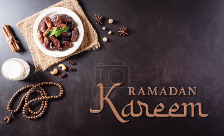 Photo for Ramadan Kareem background concept, Rosary bead with dates fruit, milk and the text on dark stone background. - Royalty Free Image