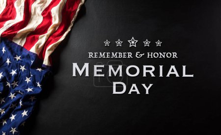 Happy memorial day concept made from american flag with text on black wooden background.