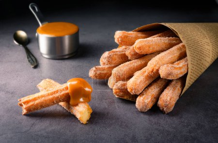 Photo for Traditional Churros with sugar and dulce de leche - Royalty Free Image