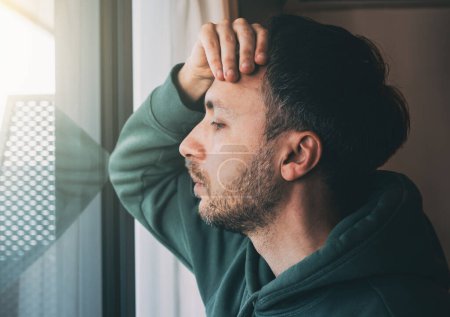 Photo for Tired man looks at window. Sad Middle-age person in life crisis or problems. Work depression or business bankruptcy concept. - Royalty Free Image
